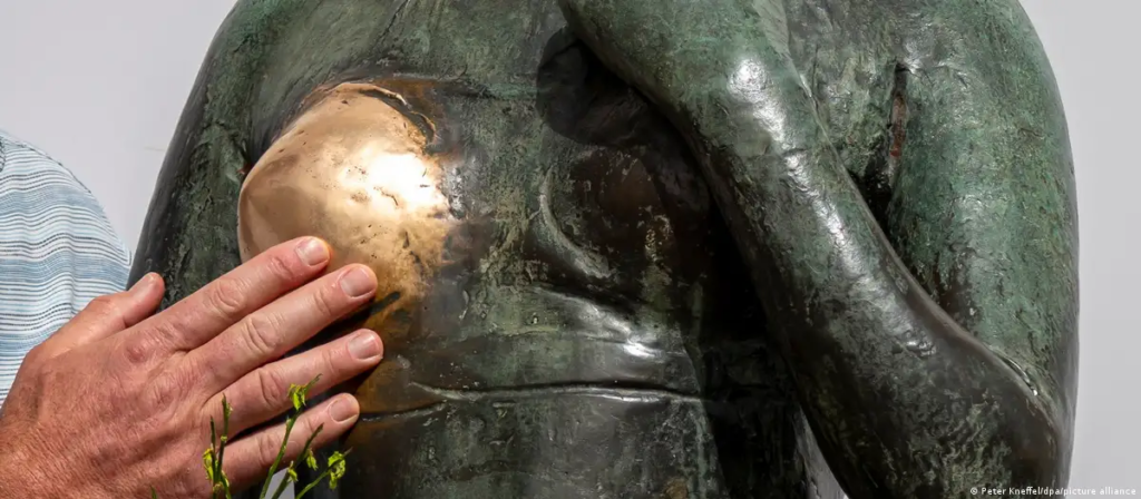 Female bronze statues with their breasts worn significantly showing sexual assault in Germany