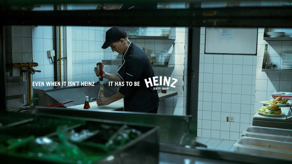 Restaurant employee filling Heinz bottle with fake ketchup