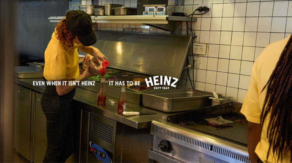 Restaurant employee filling Heinz bottle with fake ketchup
